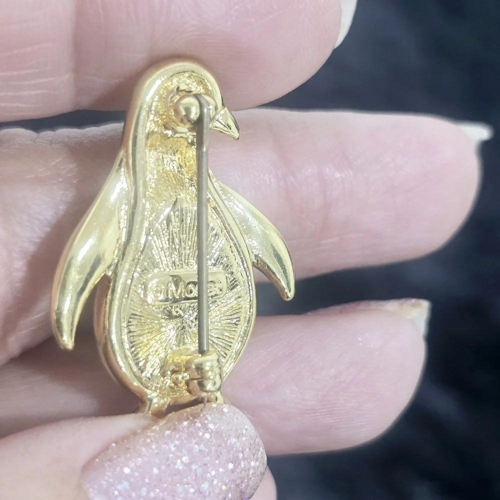 Monet Jewelry Two gold-tone leaf and penguin brooches